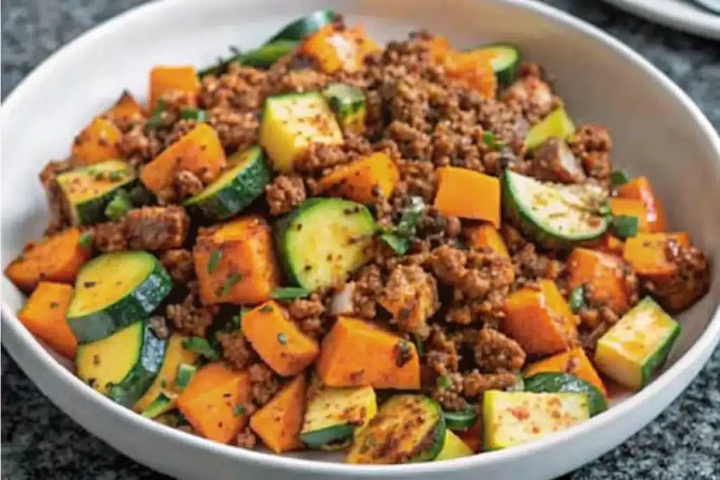 Ground Beef Zucchini Sweet Potato Skillet served in a large skillet, showcasing vibrant vegetables and savory ground beef.