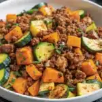 Ground Beef Zucchini Sweet Potato Skillet served in a large skillet, showcasing vibrant vegetables and savory ground beef.